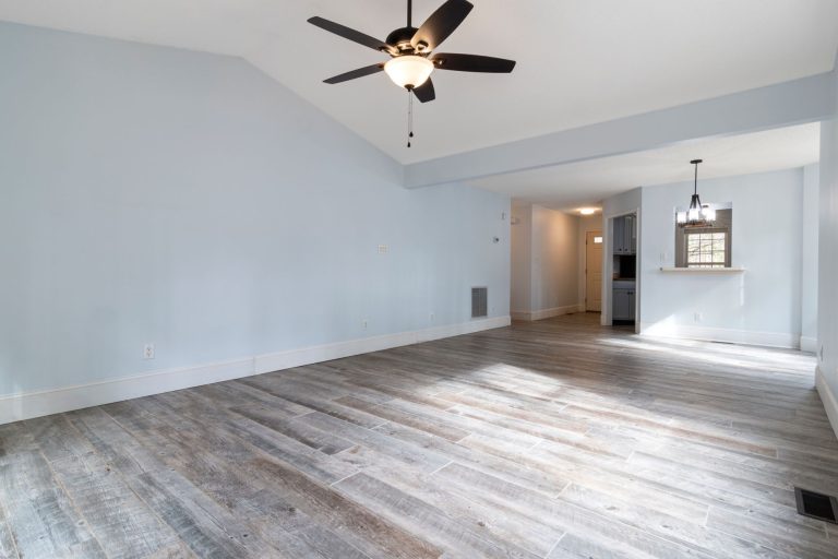 Wood-look plank flooring in an empty Ohio bedroom with a ceiling fan