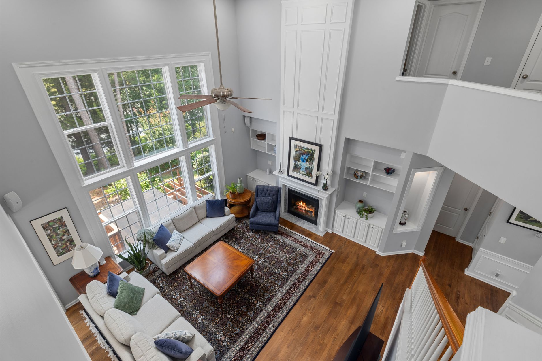 Hardwood flooring in a two-storey Ohio living room with a fireplace