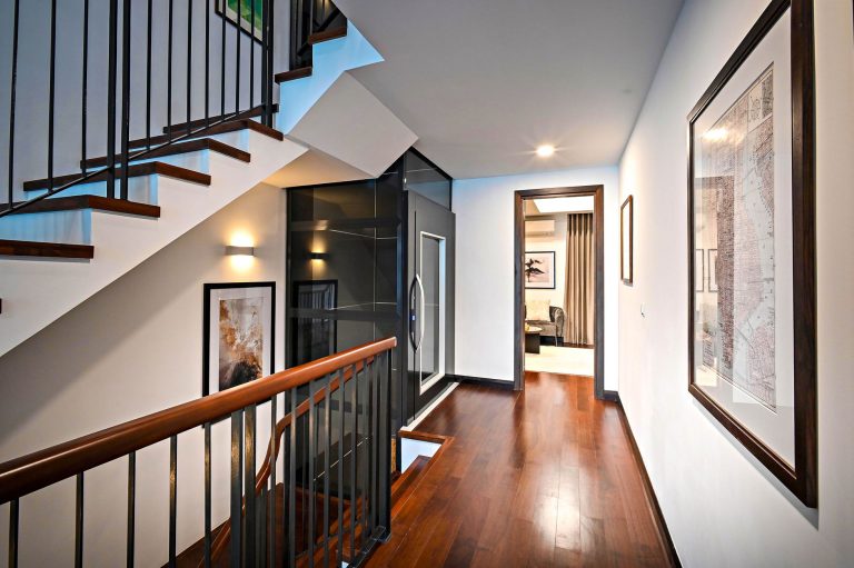 Refinished hardwood flooring on an upstairs landing beside a staircase