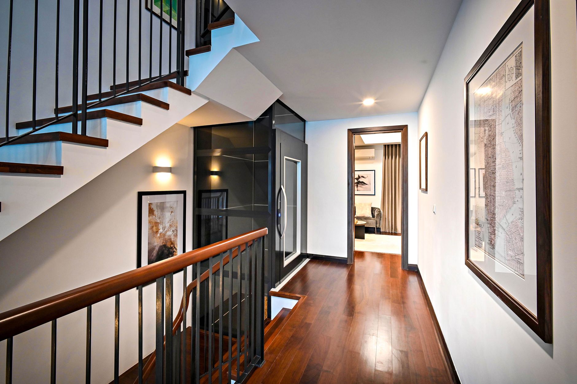 Refinished hardwood flooring on an upstairs landing beside a staircase