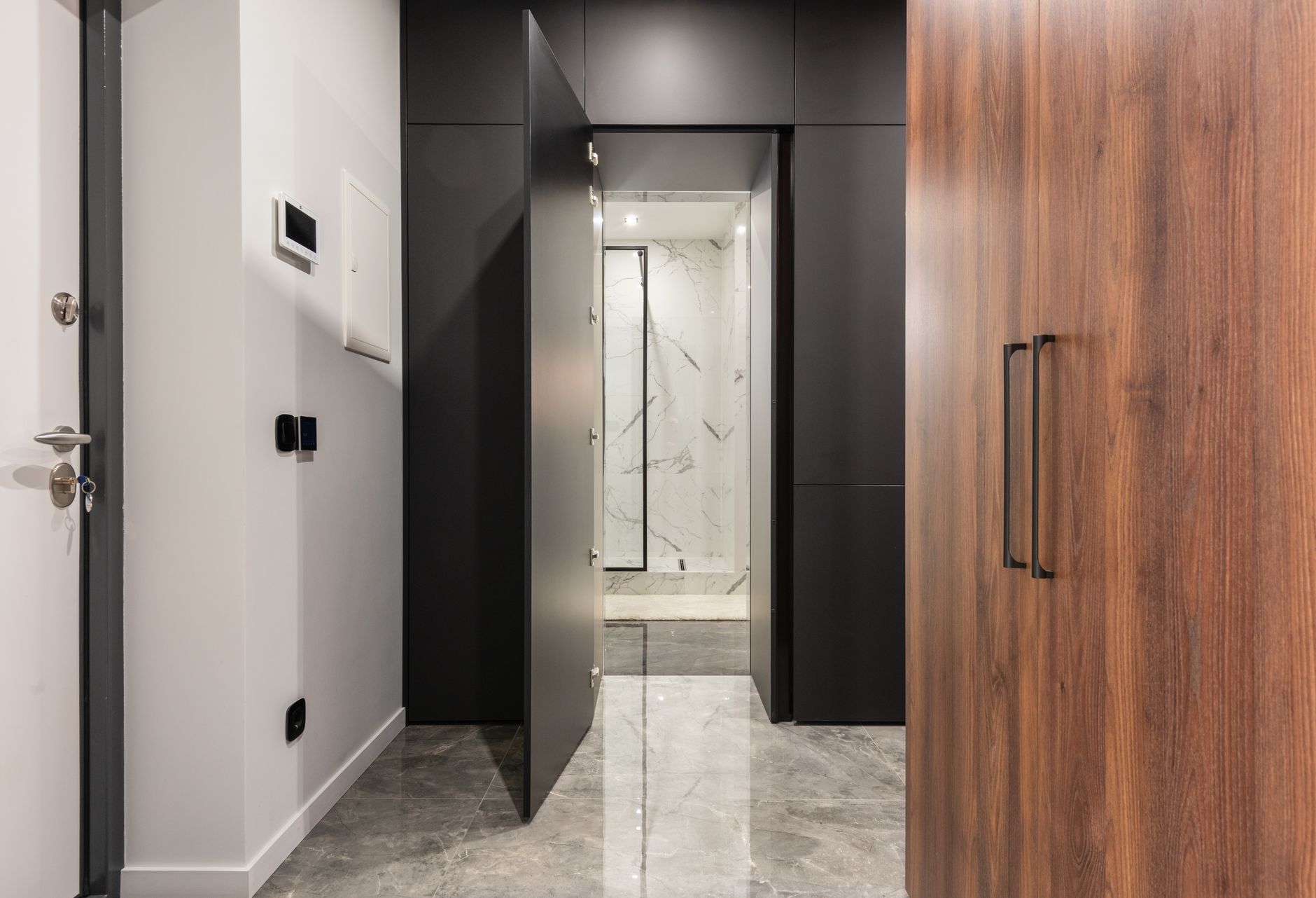 Polished natural stone flooring in a residential entry hallway